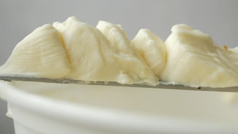 close-up of slices of creamy butter on a knife