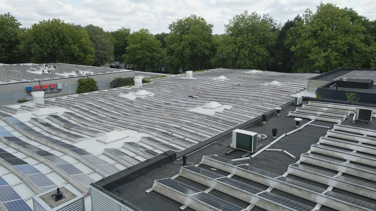 Low aerial of photovoltaic solar panels on a flat rooftop of an office building