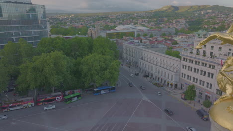 Close-dolly-shot-past-the-Freedom-Monument,-Liberty-Square,-Tbilisi,-Georgia