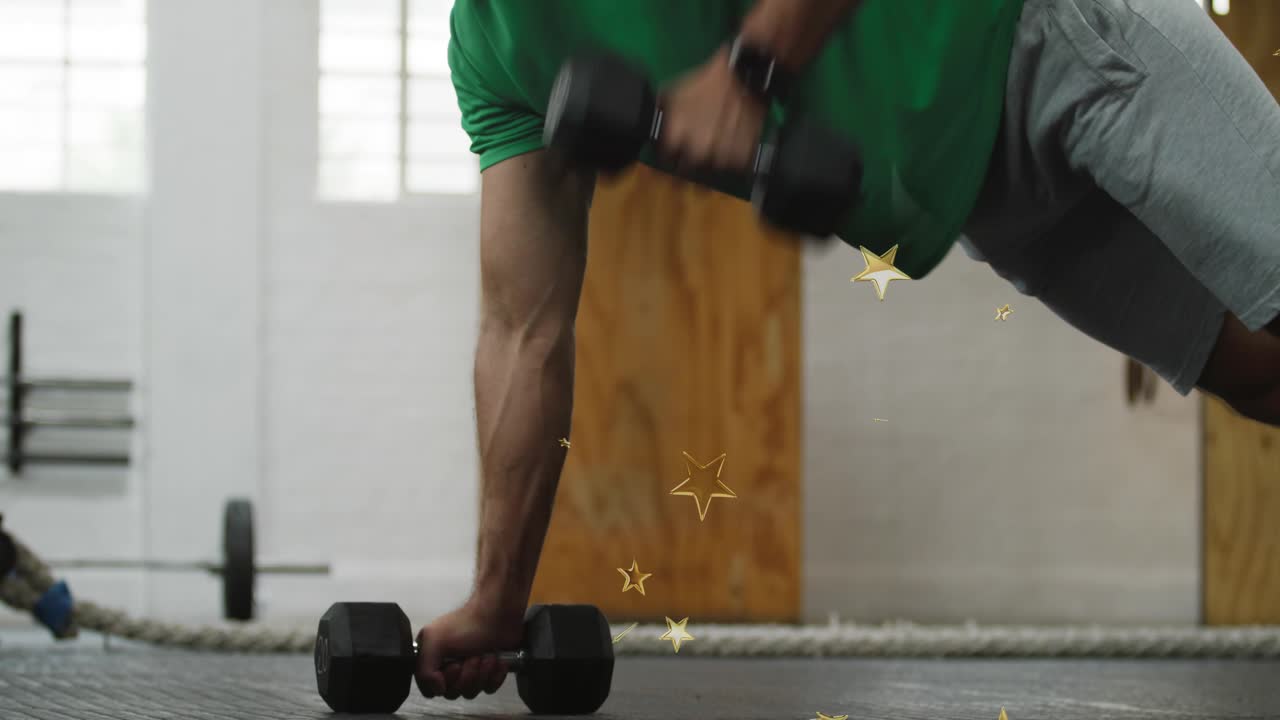 Man gripping hex weights doing alternating plank rows while star overlay appearing building fitness