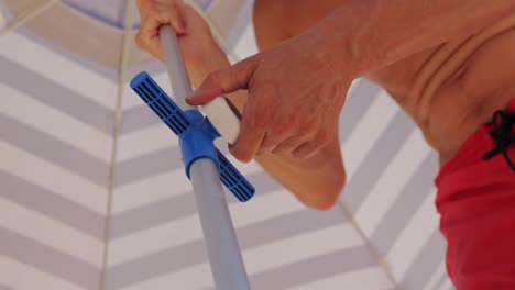 setting up a beach umbrella