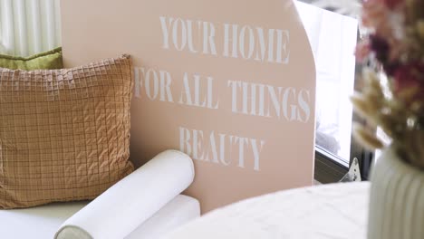 Slow-revealing-shot-of-a-beauty-sign-with-floral-decorations-in-a-waiting-room