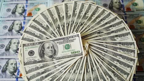 rich background of dollars. one hundred dollar banknotes rotating in a circle way. american money on the table. dollar currency spinning.