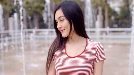 beautiful young woman in front of fountains