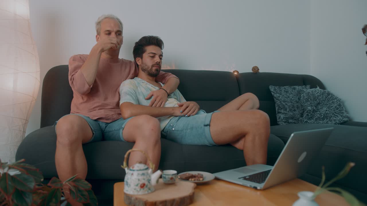 Couple Watching a Movie on Laptop at Home