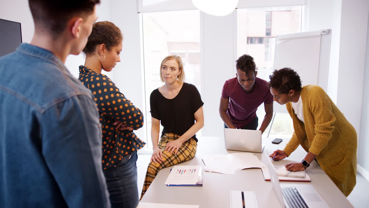 Young creative business team brainstorming in a meeting room, selective focus