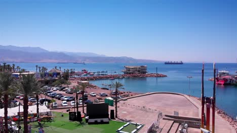 aerial view of a coastal harbor and marina with distant mountains