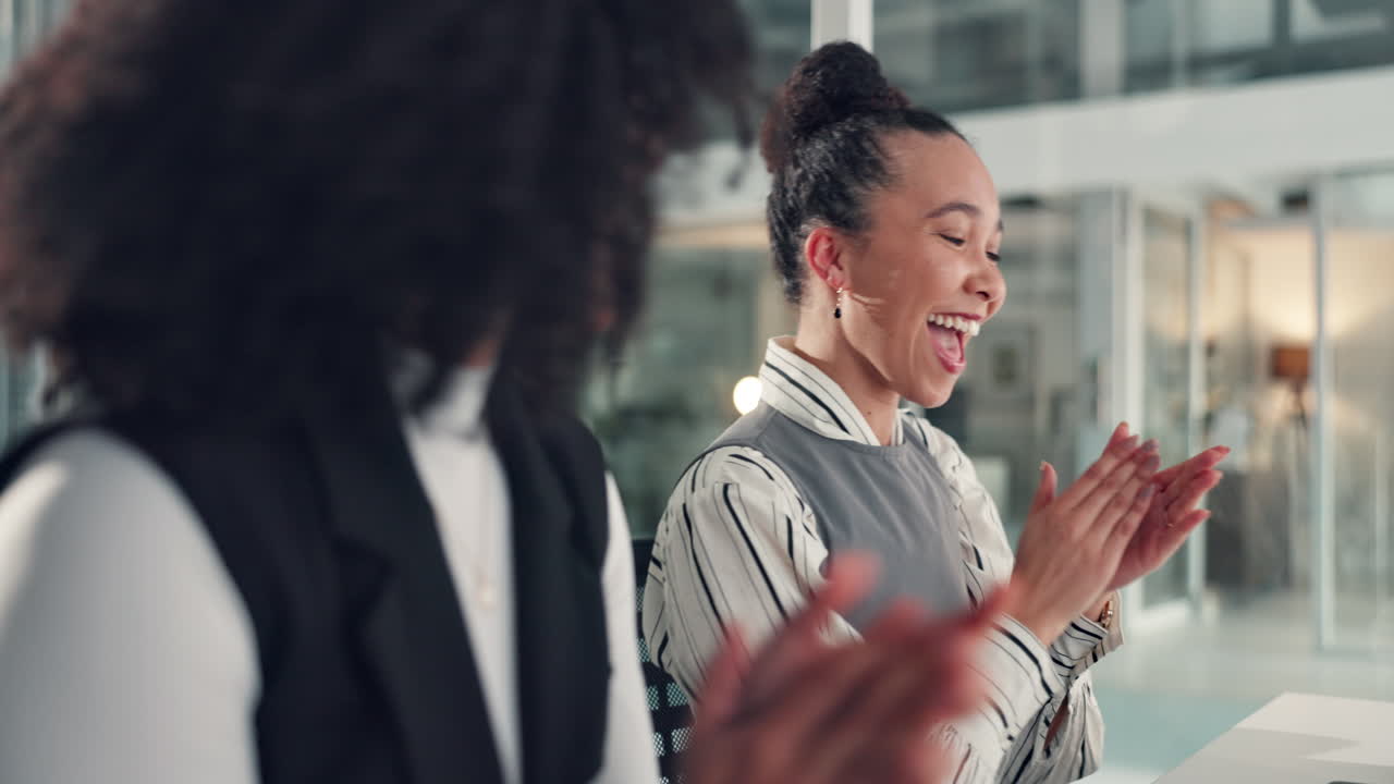 Business women celebrate success with high five in modern office