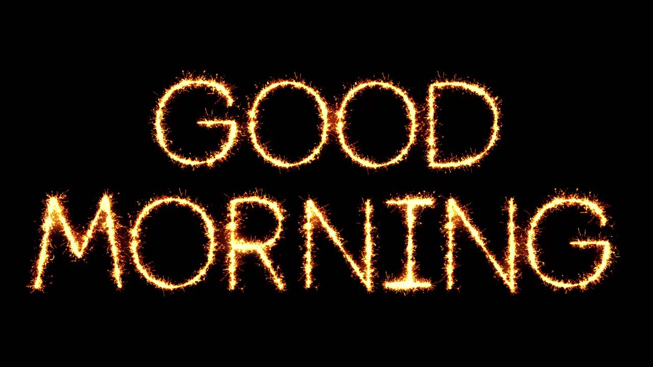 Testo Buongiorno con scrittura a scintille, particelle glitterate e fuochi d'artificio su sfondo nero in loop 4K.