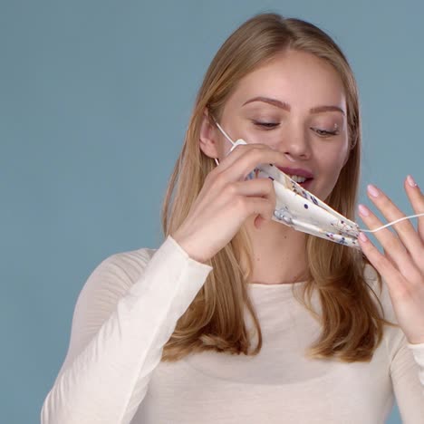 adorable smiling young girl taking on her face mask against viruses  slow motion video