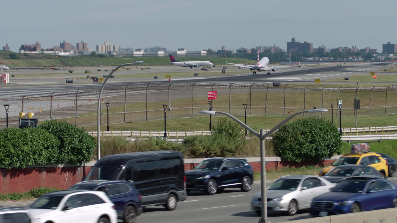 LaGuardia Airport Runway with Highway Traffic in Foreground
