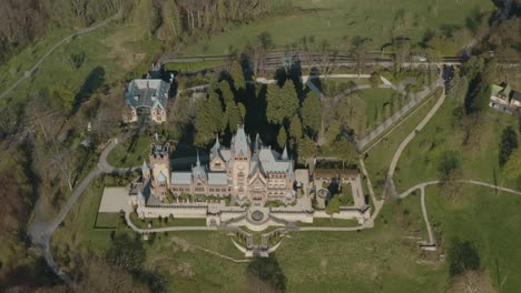 drone - aerial shot of the castle drachenburg with the drachenfelsbahn train of drachenfels in the background siebengebirge near bonn - königswinter 30p