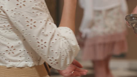 priest giving communion to parishioners in a church