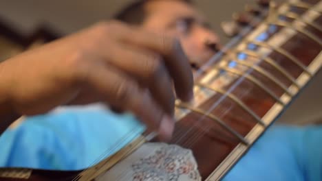 man playing the sitar