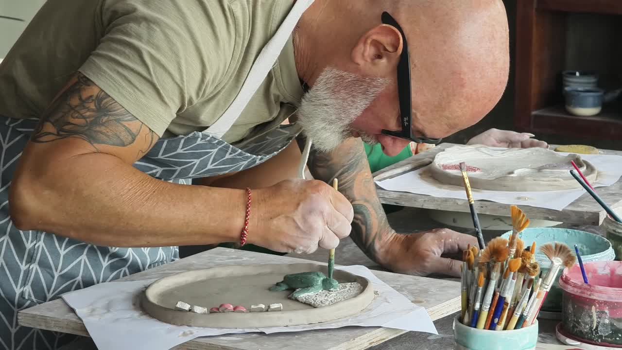Couple Painting Handmade Pottery in an Art Studio