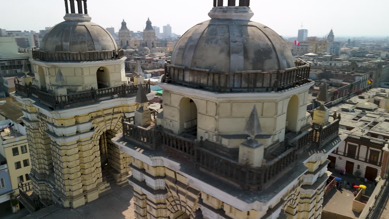 A dramatic close-up aerial parallax shot moves between the twin bell towers of the historic San Francisco Convent, revealing the intricate details of its Spanish colonial architecture