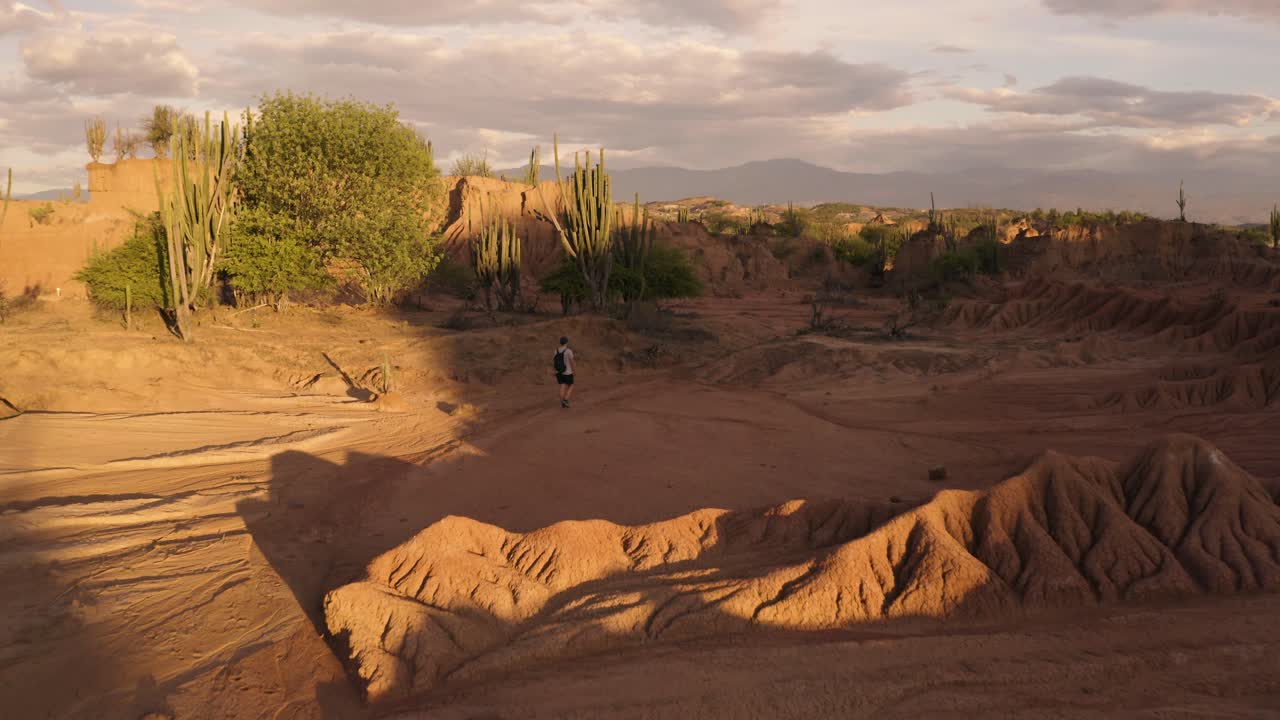Aerial flies over a Guy in the Tatacoa Desert during Sunset, Colombia