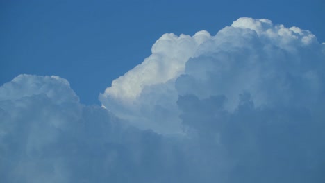 A-timelapse-of-puffy-white-clouds-passing-by-and-morphing-quickly