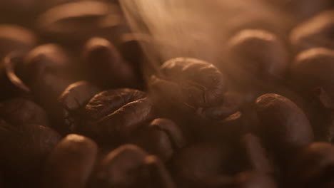 fragrant roasted coffee beans surrounded by wispy smoke trails, macro close up shot