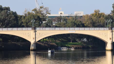 boat passing under bridge on yarra river