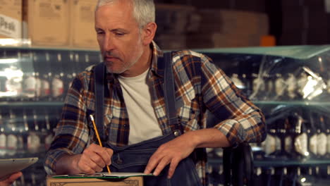 brewery workers checking info on a tablet