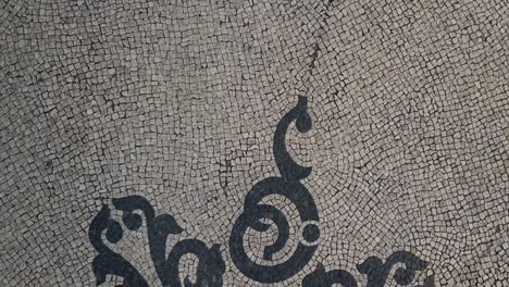 Cobblestone-pattern-on-a-Lisbon-walkway-as-seen-from-above