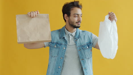 man holding paper bag and plastic bag