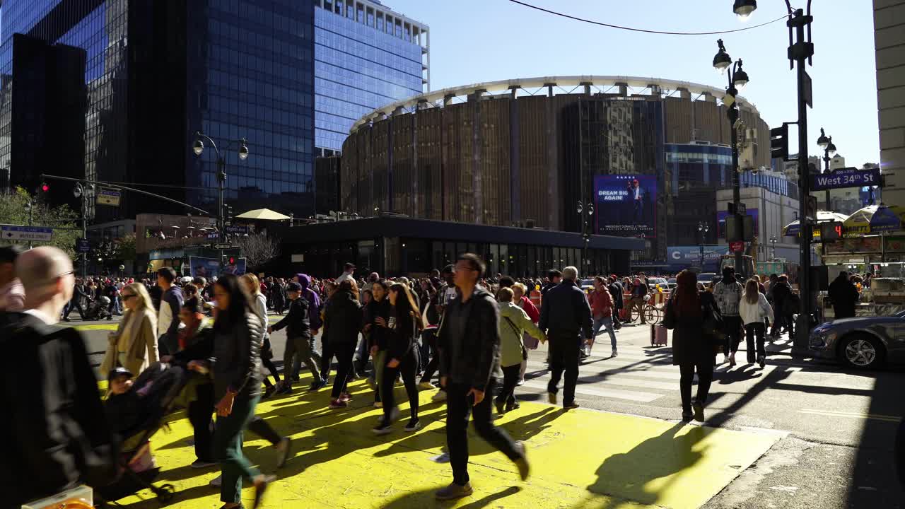 Sunlight bathes the gathering crowd near Madison Square Garden, as people come together in support of Trump, their voices filled with enthusiasm
