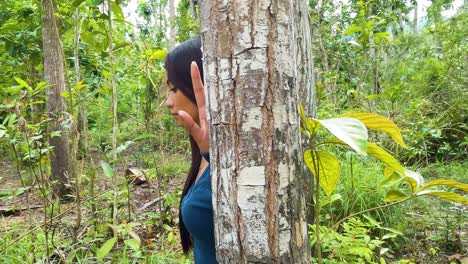 Lone-Woman-Isolated-In-A-Forest-With-Tropical-Trees-During-Daytime