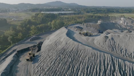 Bulldozers-moving-material-on-top-of-a-large-hill-of-gravel