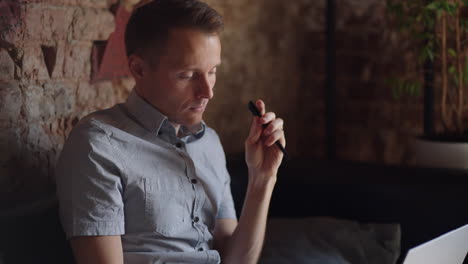 thoughtful 30s man thinking of problem solution working on laptop. serious doubtful male professional looking away at laptop considering market risks making difficult decision sitting at desk