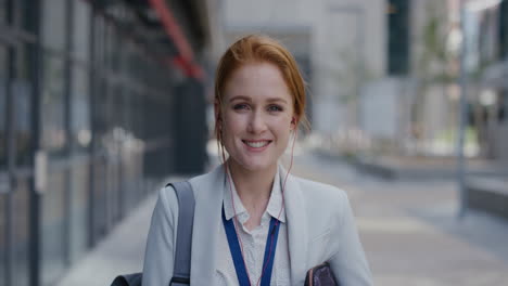 portrait independent young business woman smiling wearing earphones enjoying relaxed urban lifestyle listening to music in city slow motion successful female