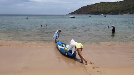 people kayaking on a tropical beach