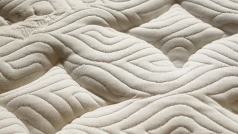 close up of a white quilted mattress texture