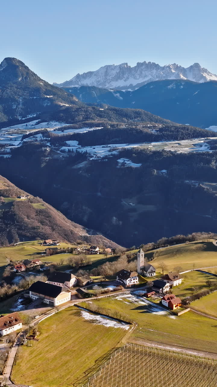 Aerial drone view of the Soprabolzano village on the Renon plateau in the Dolomites, Italy. Vertical