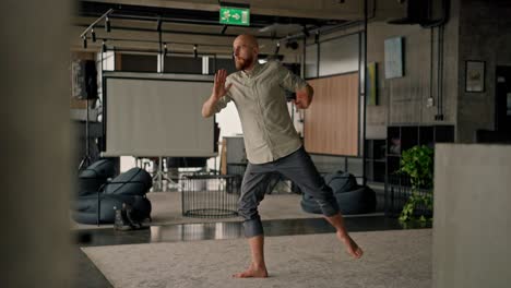 man practicing yoga and meditation in an office setting