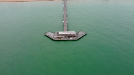 4k high altitude drone footage of deal pier to reveal the beach and the town