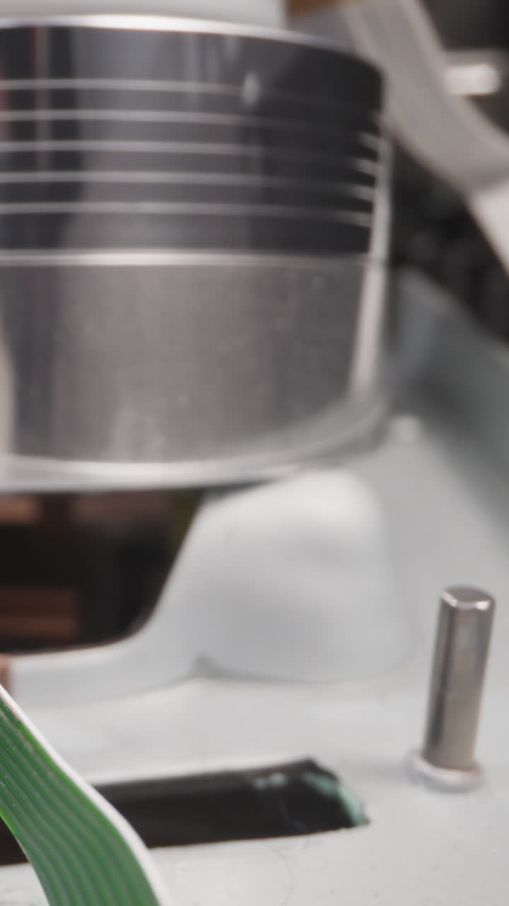 Runner pulls tape to head and microchip of videocassette recorder in room macro view. Vintage device to watch video. Inside mechanism observe