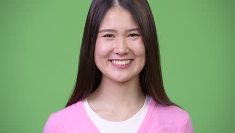 young happy beautiful asian woman smiling