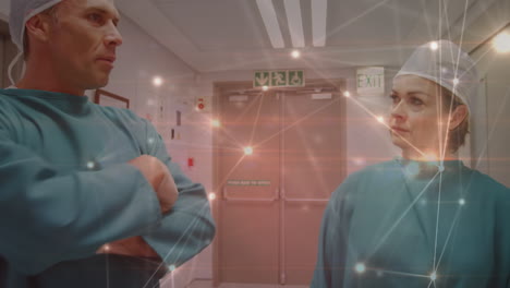 animation of network of connections over two caucasian surgeons in operating theater