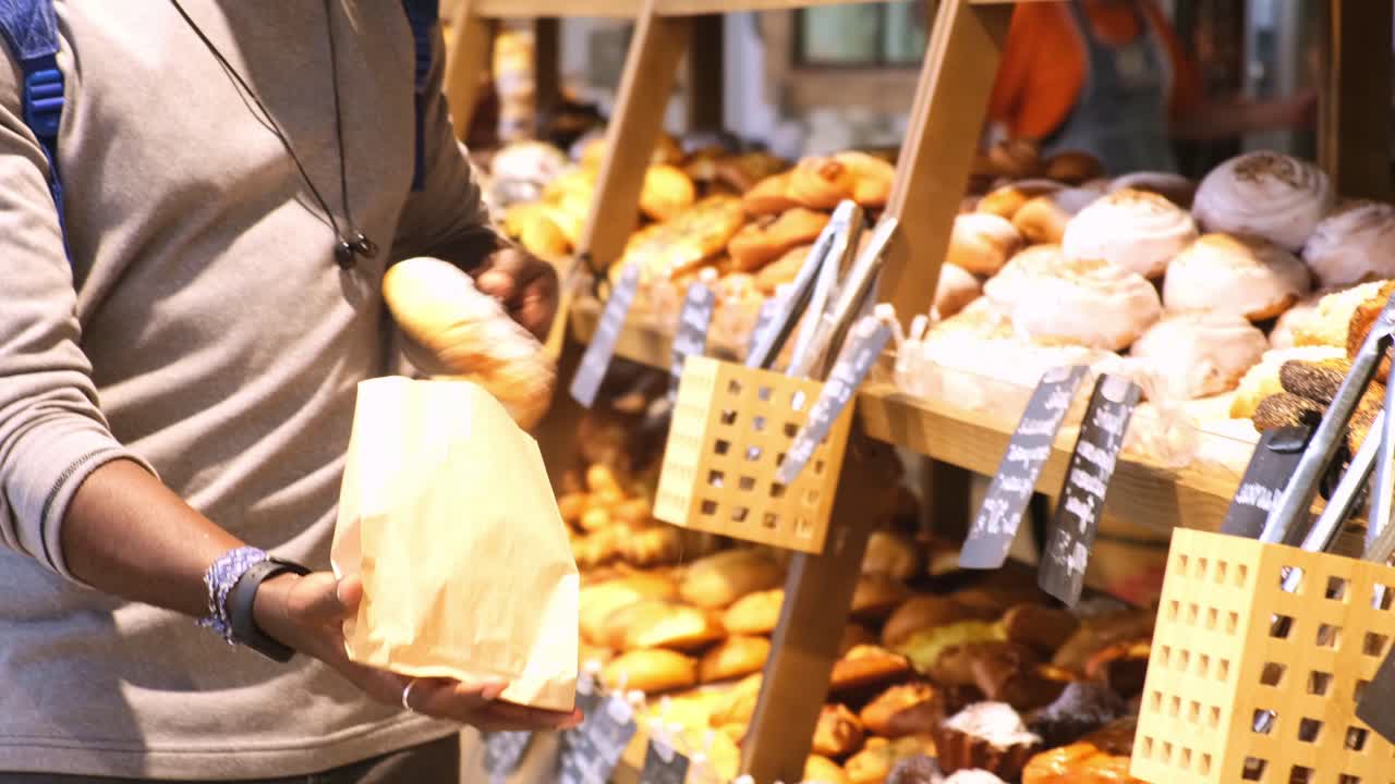 Exploring Fresh Bakery Delights: A Person Caught in a Moment While Deciding on Delicious Pastries and Breads in a Local Store Environment