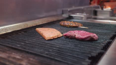 the cook is oiling the fresh meat and adding a new part of meat