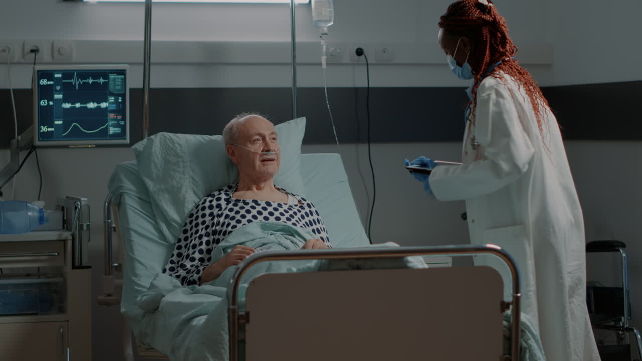 African american medic fixing adjustable bed for patient