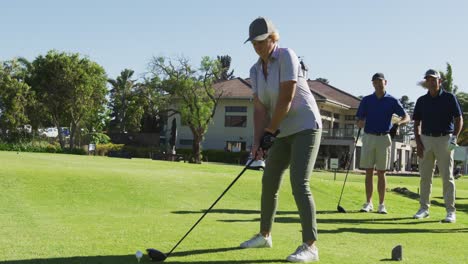 Caucasian-senior-woman-practicing-golf-at-golf-course-on-a-bright-sunny-day