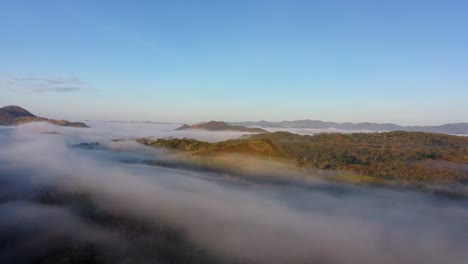 Mountains-and-hilltops-peaking-over-low-cloud-cover-in-the-morning