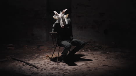 goat mask person in abandoned basement