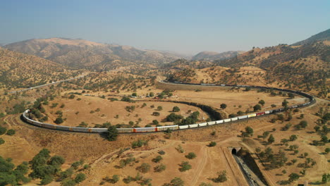 long union pacific train rolling around the tehachapi loop - aerial view