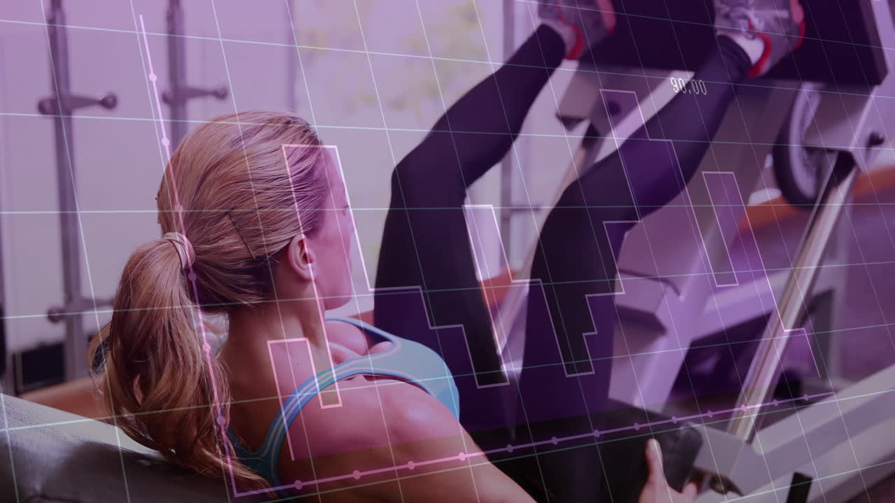 Mid adult woman performing leg press in gym, showing fitness technology with animated bar graph