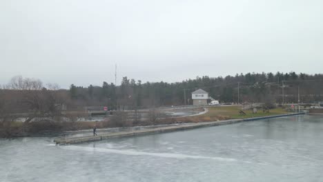 aerial-drone-following-a-young-woman-on-a-winter-day