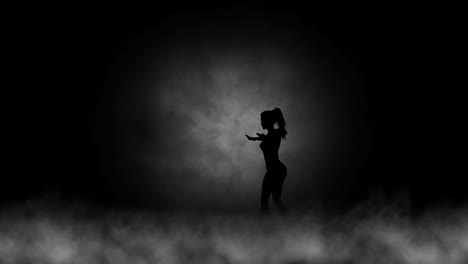 A-modern-youth-dance-performed-by-a-graceful-and-sexy-female-silhouette,-in-the-smoke-against-the-backdrop-of-spotlights